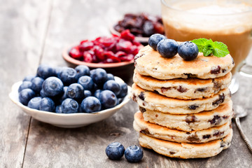 Stack  of welsh cakes with blueberry and a cup of coffee