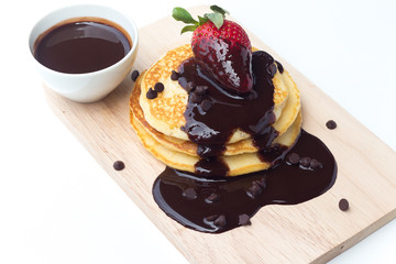Pancakes with chocolate syrup and strawberry