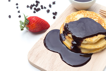 Pancakes with chocolate syrup and strawberry