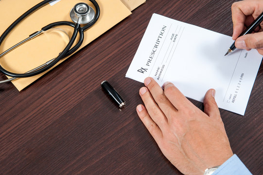 writing prescription / doctor writing prescription on the table