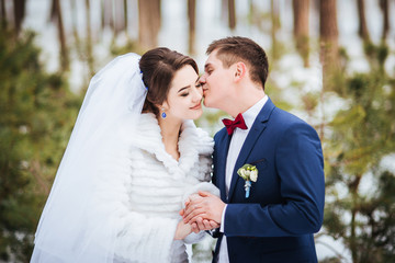 Happy bride and groom in winter day on their wedding