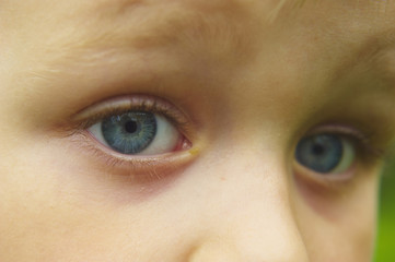 Child boy's blue eye close-up. Kids emotion. Outdoor 
