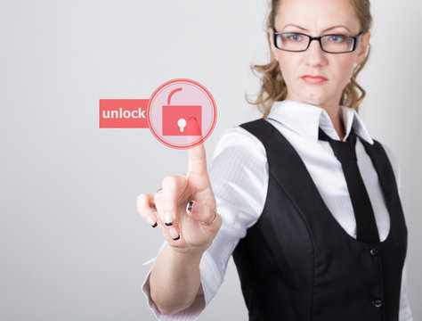 technology, internet and networking concept. beautiful woman in a black business shirt. woman presses unlock button on virtual screens