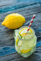Jar with infused detox water on wooden table