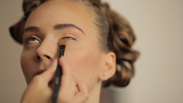 young model make-up artist paints the eyes