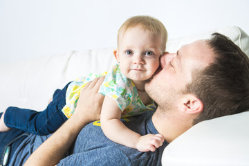 father with baby on the sofa taking good time