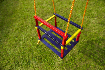 swing on an empty playground. Concept for child protection, abduction or loneliness