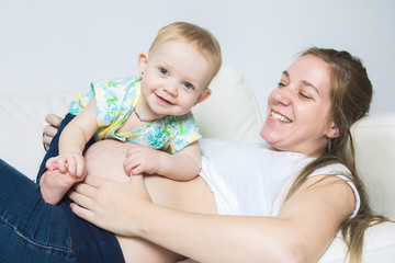 Mother with baby on the sofa taking good time