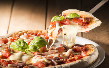 Pizza with bacon on the wooden table