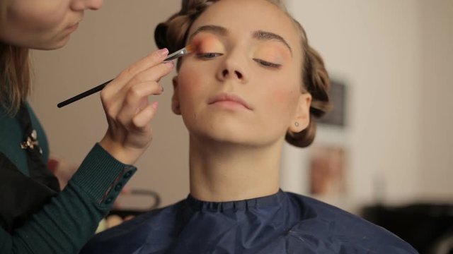 Make-up artist doing make-up before the show models