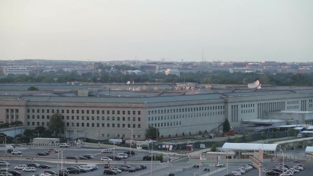 The Pentagon building and the airplane flying on the sky in Washington DC, USA.