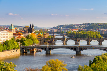 Obraz premium View of the Vltava River and the bridges shined with the sunset sun, Prague, the Czech Republic