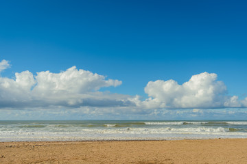 Fototapeta na wymiar Clouds,surf and sand