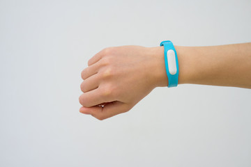 Blue fitness tracker closeup on a female hand