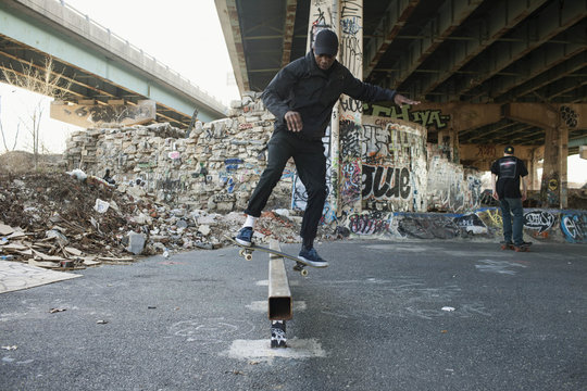 A young man skateboarding.
