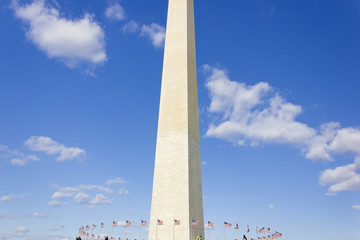 Obraz premium Gleaming white stone & two-tone stonework of America's national monument, the Washington Monument with fifty American flagpoles circling the plaza below, The Mall, Washington DC