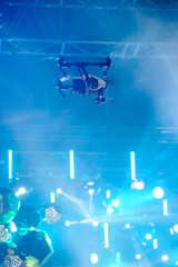 Hovering drone on stage/Professional camera drone flying over the scene during concert