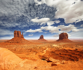 view of monument valley under a cloudy sky © Paulista