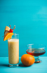 Banana cocktail with fruit decoration on the wooden background