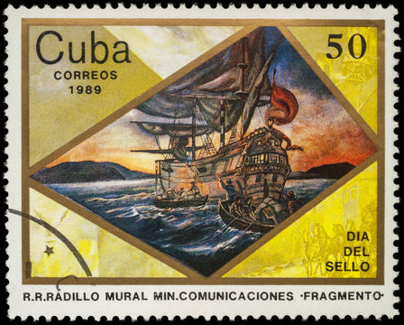 Sailing ship and boats with sailors on postage stamp