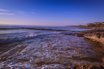 Sunrise at rocky beach in urban Australia