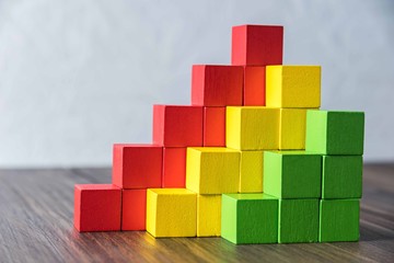 Fototapeta premium Colorful stack of wood cube building blocks