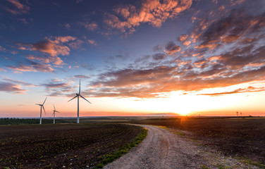 Wind turbines with power line in the sunset!