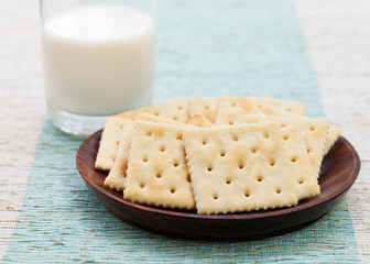 Square biscuit cracker with fresh milk in a bowl
