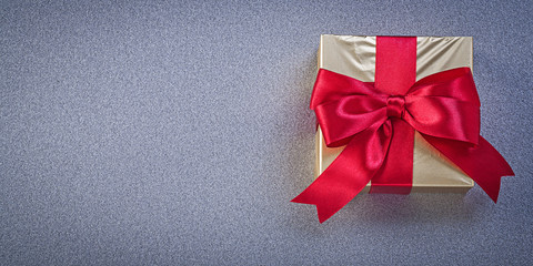 Wrapped box with presents on grey background holidays concept