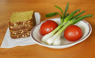 Fresh vegetables with greens and rye bread