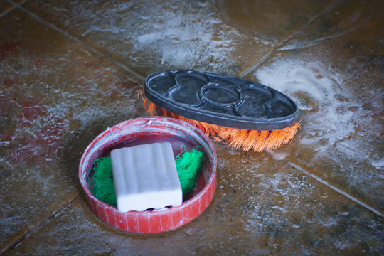 Traditional Indian soap and duster on the floor. - Powered by Adobe