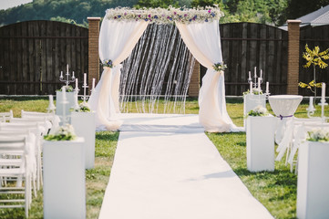 the place of the wedding ceremony. decor, chairs and an arch of flowers.