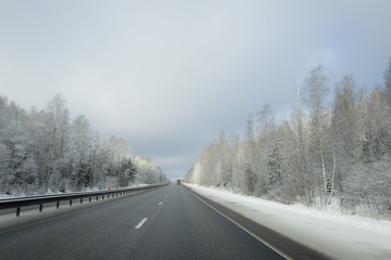 Fototapeta na wymiar Winter road with frozen trees