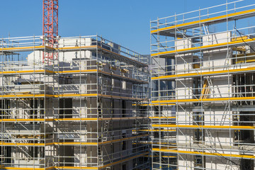 Baustelle - zwei Häuser mit Gerüst und Kran