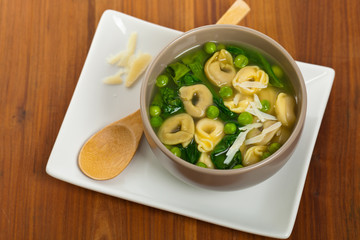 Tortellini Soup with Peas and Spinach. Selective focus.