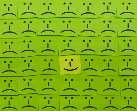 Happy and unhappy concept. Background of Sticky Notes.
