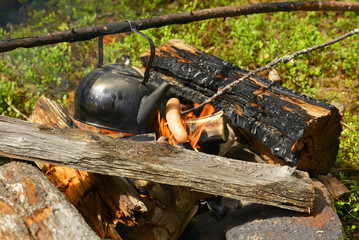 Kettle on the fire. Making coffee in a hike in the woods