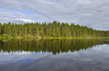 Fototapeta na wymiar Northern landscape with a lake. Reflection