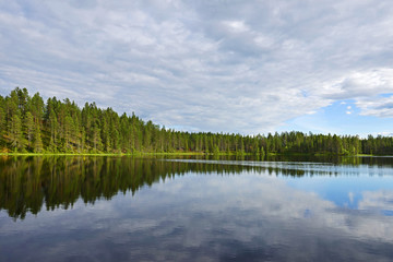 Fototapeta na wymiar Northern landscape with a lake. Reflection
