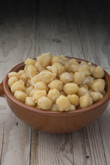 Chickpeas on glass bowl on wooden table