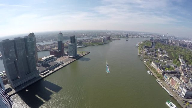 Aerial of Rotterdam city moving over Erasmus Bridge Erasmusbrug showing business dsitrict left Euromast building right cityscape bird view of city center large city in south of Netherlands Holland 4k