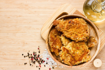 Pork chops coated in bread crumbs top view blank space for text