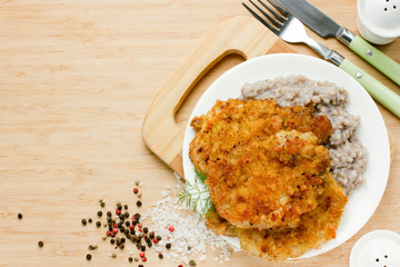 Meat chop in bread crumbs garnished with green buckwheat