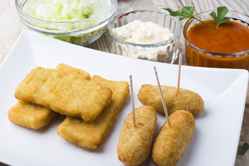 croquettes balls and different kind of sauces on a plate on a cl