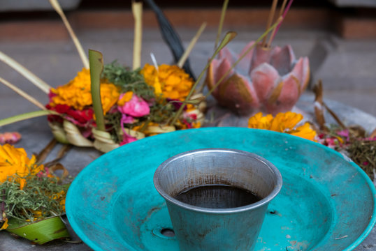 Religious offerings in Bali, colored flowers with turquoise dish