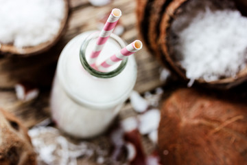 Coconut milk in glass bottle with straw