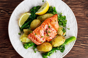 Pan fried Salmon Served with potatoes and tenderstem broccoli.