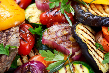 Close up Grilled vegetables. On cutting dark board