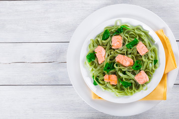 Salmon and Spinach Fettuccine pasta on white dishes