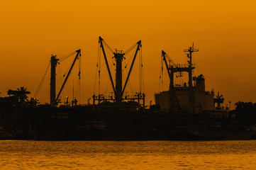 Sunset over dock ship or harbor near river